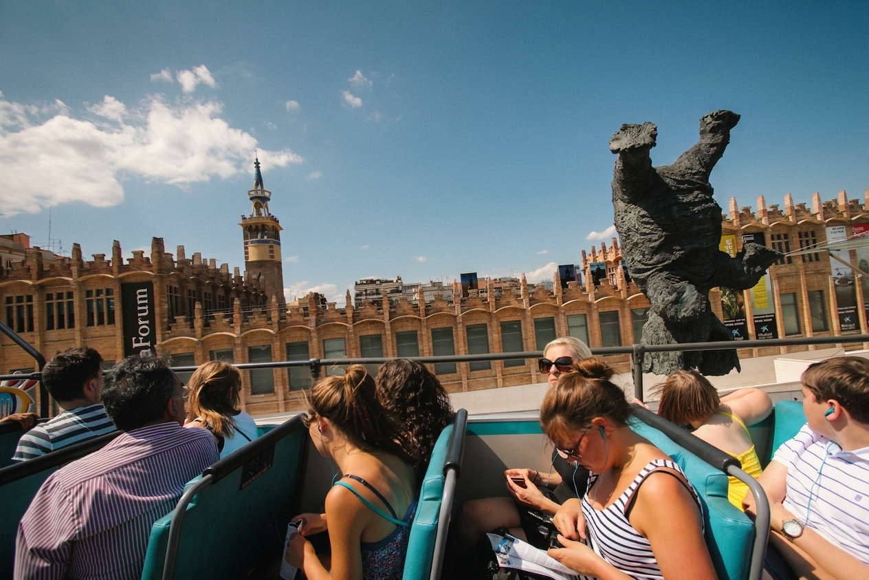Tourists on the open top deck of a sightseeing bus in Barcelona